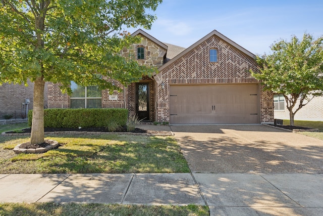 view of front facade with brick siding, an attached garage, a front yard, stone siding, and driveway