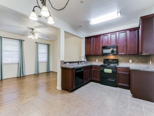 kitchen with backsplash, ceiling fan with notable chandelier, black appliances, decorative light fixtures, and light hardwood / wood-style floors