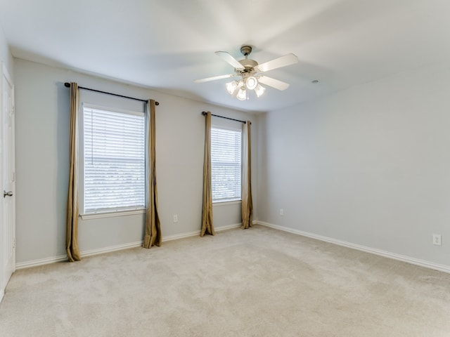 unfurnished room with ceiling fan and light carpet