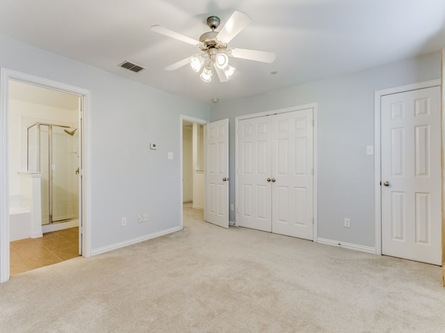 unfurnished bedroom with light carpet, connected bathroom, and ceiling fan