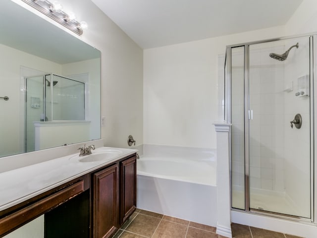 bathroom featuring tile patterned floors, vanity, and plus walk in shower