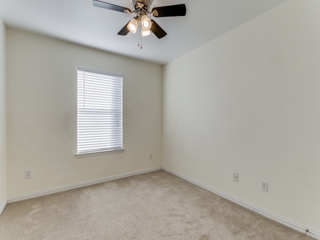 carpeted spare room with ceiling fan