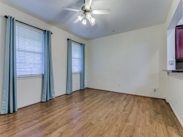 spare room featuring ceiling fan and light hardwood / wood-style floors