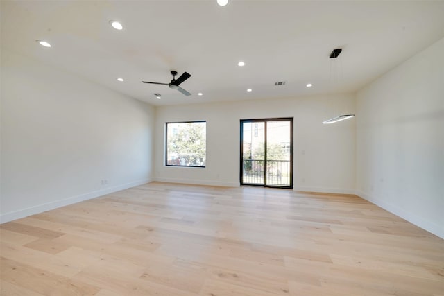 spare room with light hardwood / wood-style flooring and ceiling fan