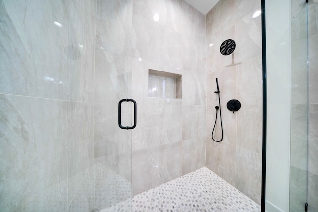 bathroom featuring a shower with door