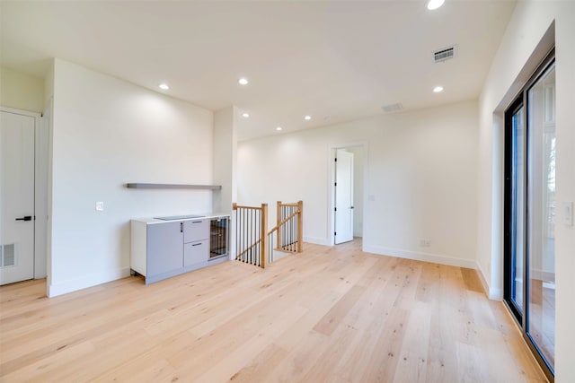 empty room with light hardwood / wood-style flooring