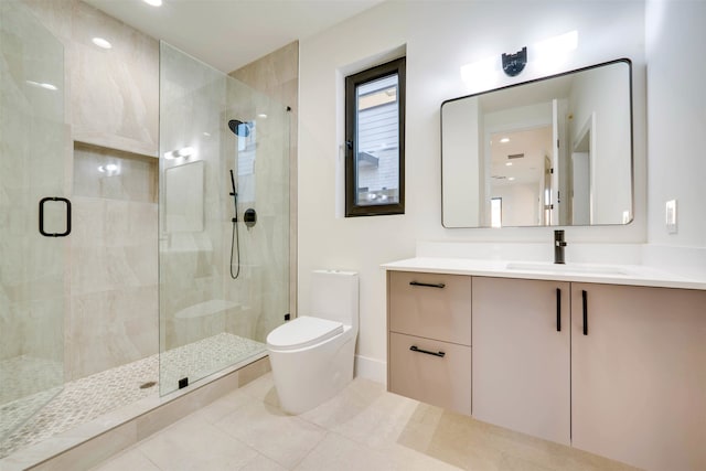 bathroom with tile patterned floors, vanity, toilet, and a shower with door