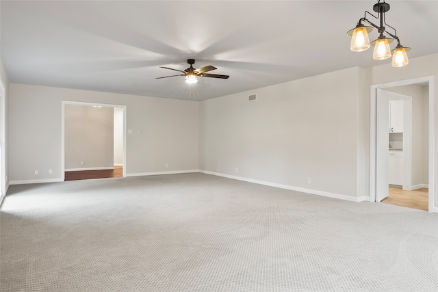 carpeted empty room featuring ceiling fan