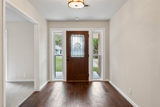 unfurnished room featuring ornamental molding, ceiling fan, and dark wood-type flooring