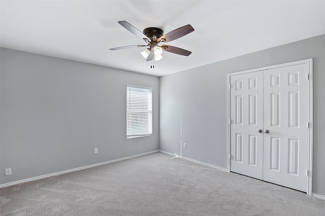 carpeted spare room with ceiling fan