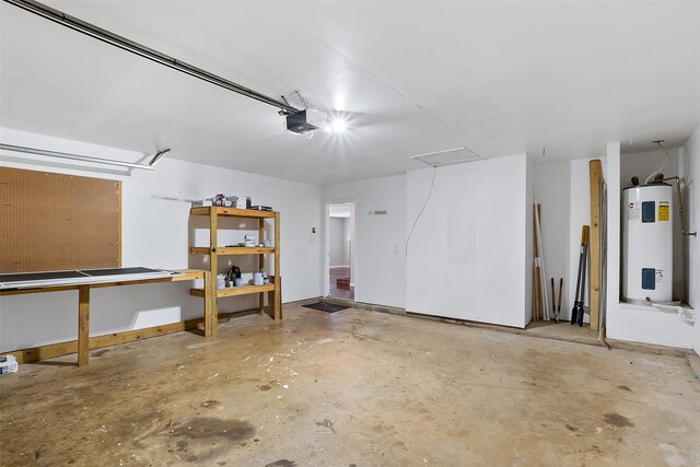 garage featuring electric water heater, a garage door opener, and a workshop area