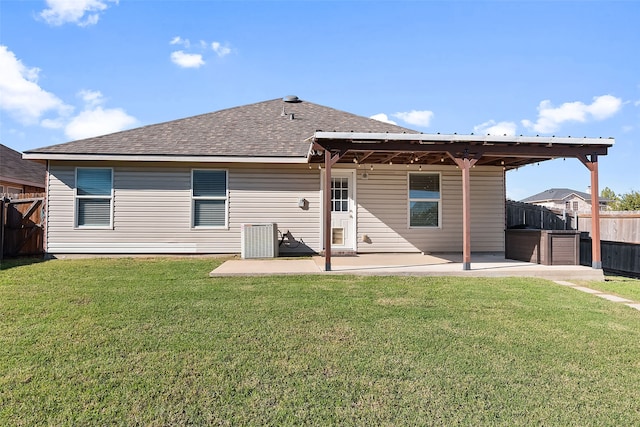 rear view of house with a yard and a patio