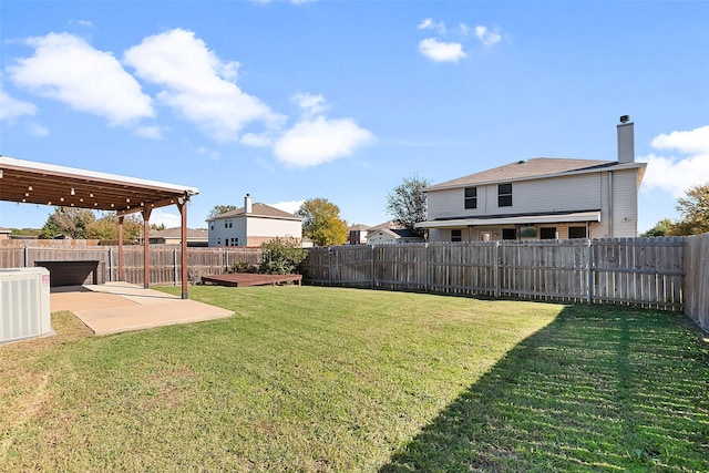 view of yard with central air condition unit and a patio