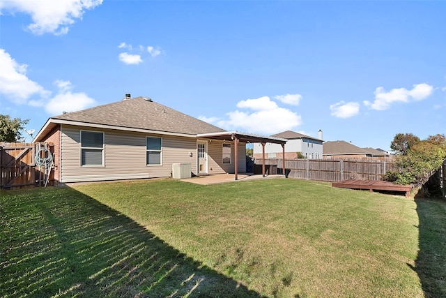 rear view of property with a lawn, a patio area, and a wooden deck