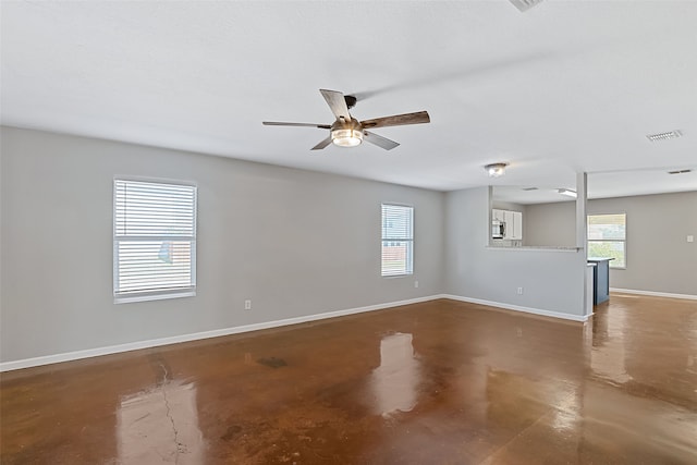 spare room featuring plenty of natural light and ceiling fan