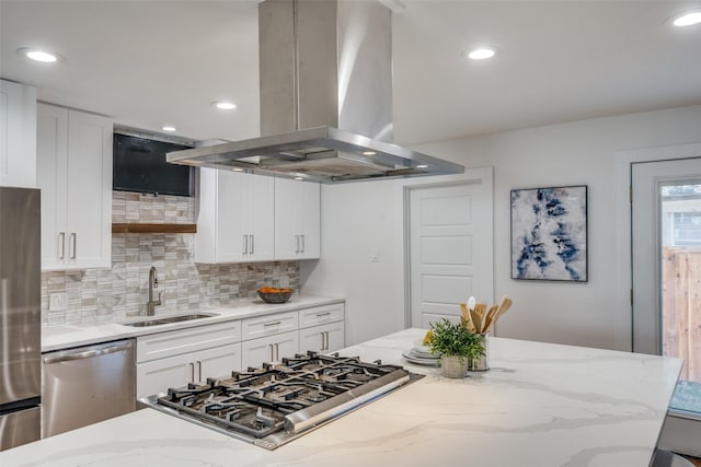 kitchen with white cabinetry, island exhaust hood, appliances with stainless steel finishes, and sink