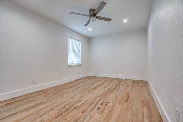 spare room with ceiling fan and light hardwood / wood-style flooring