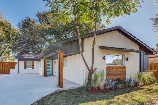 view of side of home with a patio area