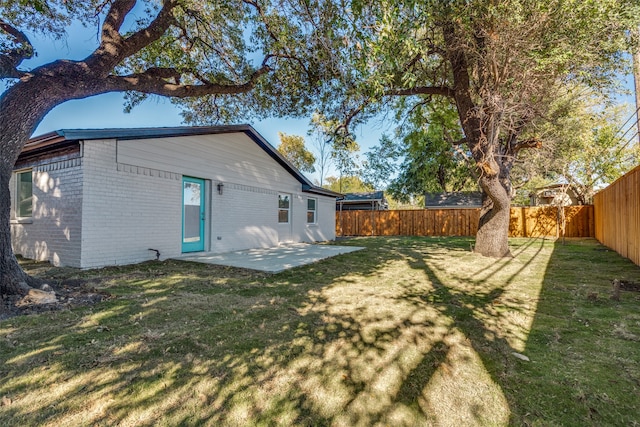 back of property featuring a yard and a patio