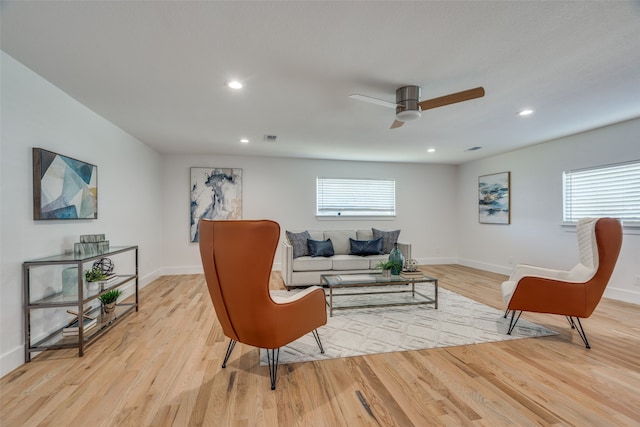 living room featuring ceiling fan and light hardwood / wood-style floors