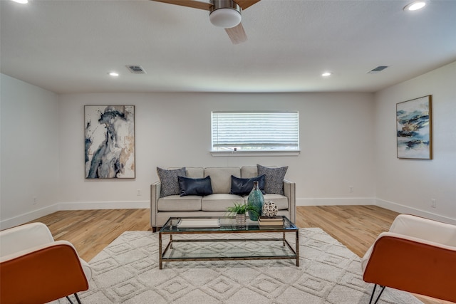 living room featuring light hardwood / wood-style floors and ceiling fan