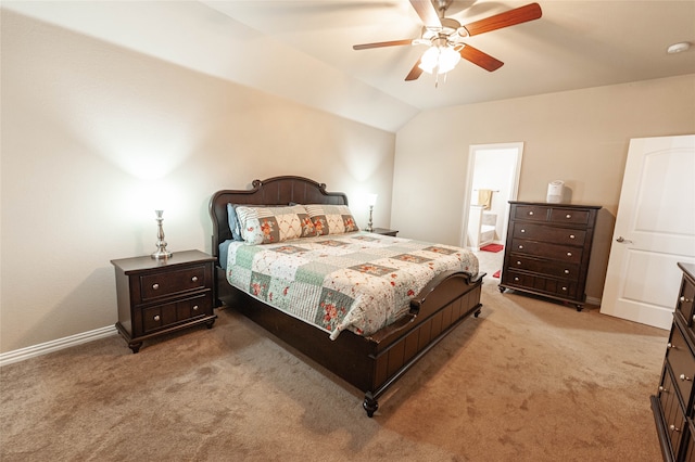 carpeted bedroom with ceiling fan, ensuite bathroom, and vaulted ceiling