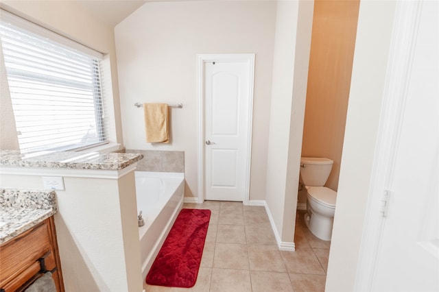 bathroom featuring a washtub, tile patterned flooring, lofted ceiling, toilet, and vanity