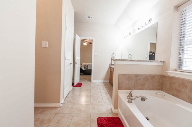 bathroom featuring tile patterned floors, vanity, a bathtub, and ceiling fan