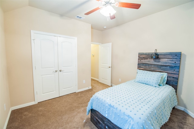 carpeted bedroom featuring ceiling fan, lofted ceiling, and a closet