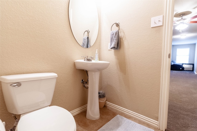 bathroom with ceiling fan and toilet