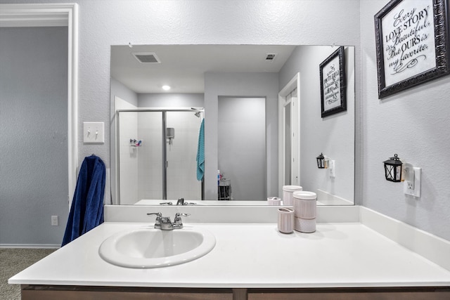 bathroom featuring vanity and an enclosed shower