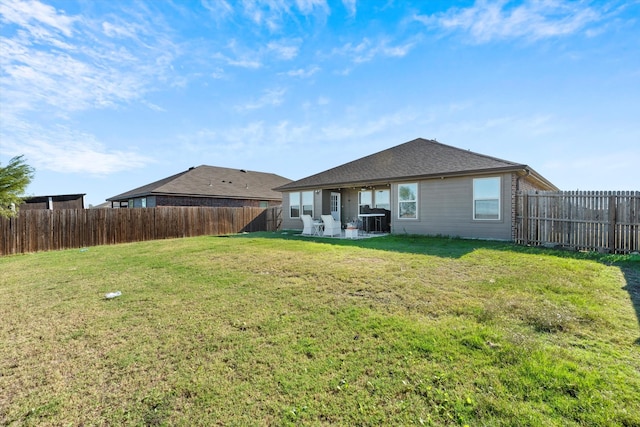 back of property with a patio area and a lawn