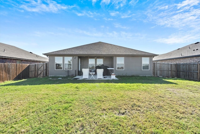 back of house with a yard and a patio area