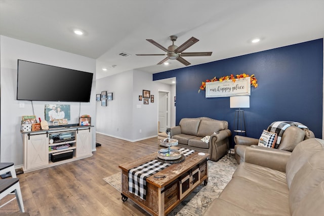 living room with ceiling fan and wood-type flooring