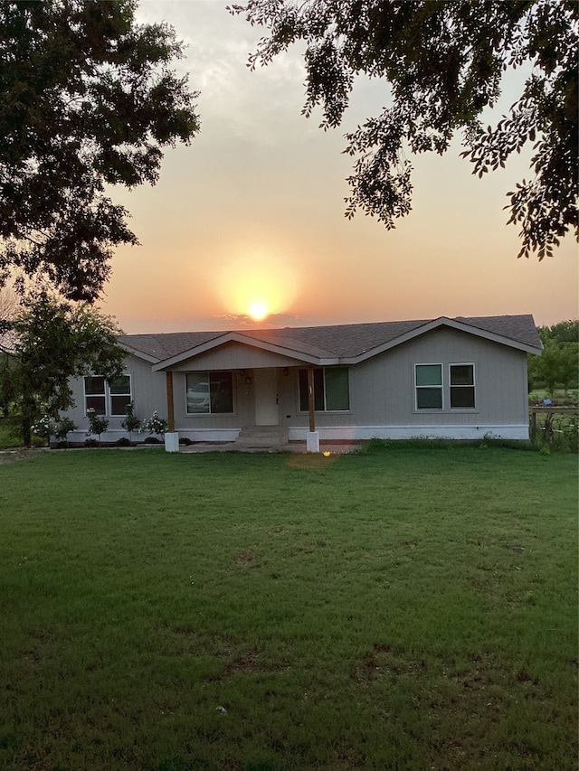 ranch-style house featuring a yard