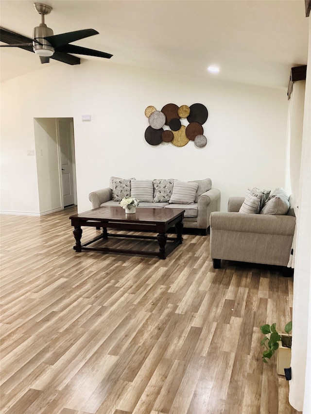 living room with ceiling fan and light hardwood / wood-style flooring