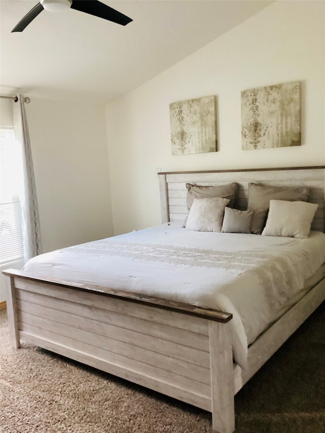 bedroom with carpet floors, vaulted ceiling, and ceiling fan