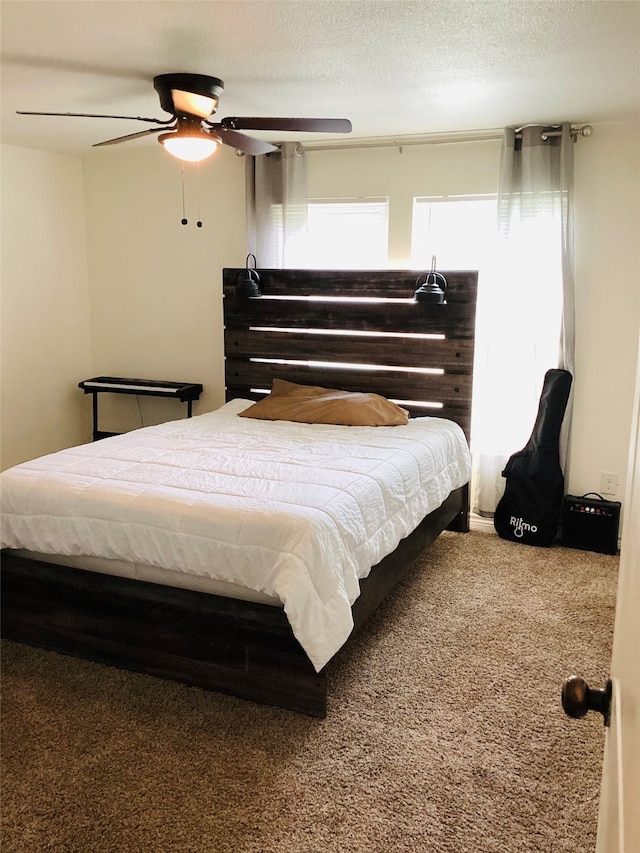 bedroom with carpet flooring, ceiling fan, and a textured ceiling