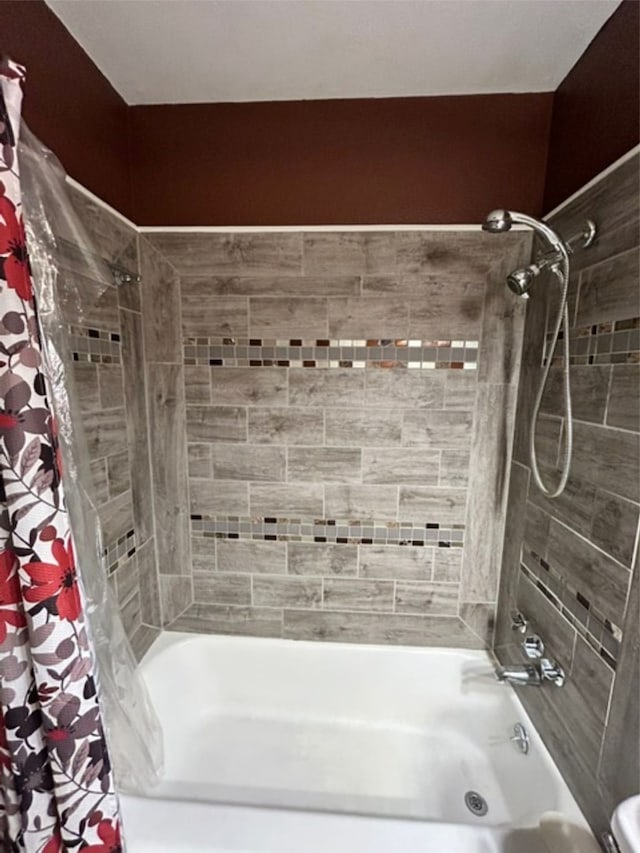 bathroom with shower / bath combo with shower curtain