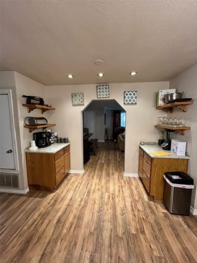 kitchen with light hardwood / wood-style flooring and a textured ceiling