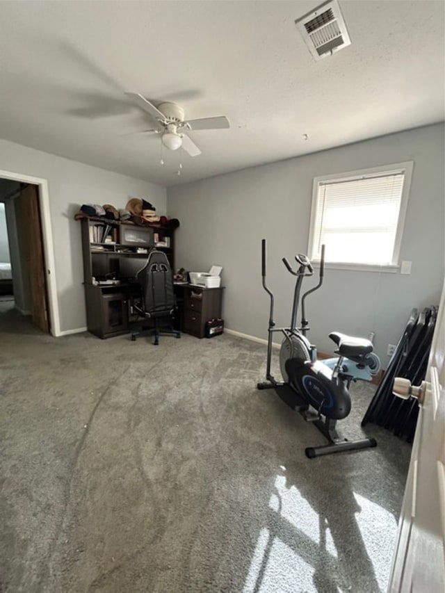 workout room featuring ceiling fan and carpet