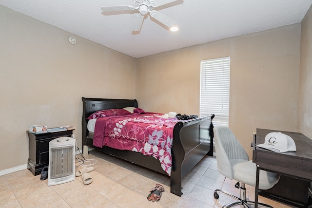 tiled bedroom with a ceiling fan and baseboards