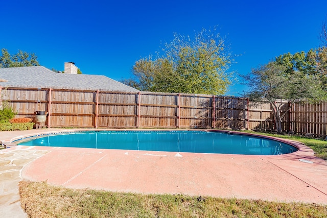 view of swimming pool featuring a patio, a fenced backyard, and a fenced in pool