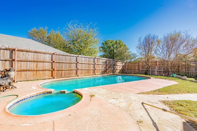 view of swimming pool with a patio area, a fenced in pool, and a fenced backyard