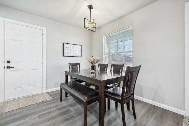 dining room featuring a chandelier and dark wood-type flooring