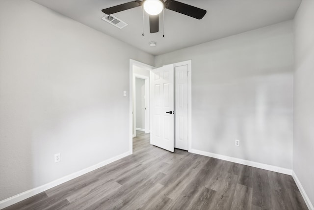 unfurnished room with ceiling fan and light wood-type flooring