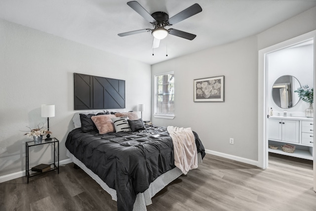 bedroom with ensuite bath, ceiling fan, and hardwood / wood-style floors