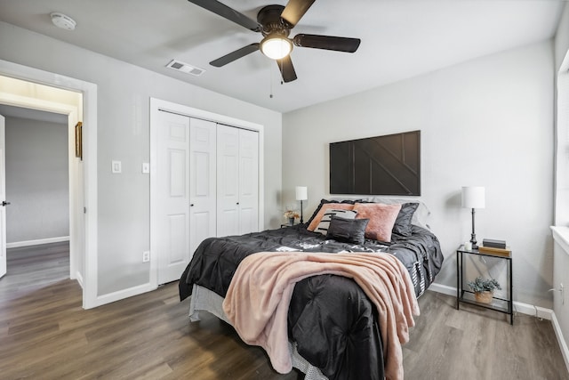 bedroom with wood-type flooring, a closet, and ceiling fan