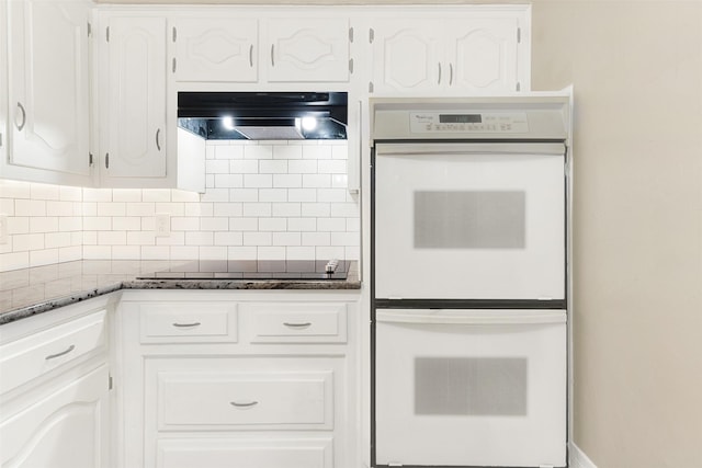 1725 Brake Dr, Carrollton, TX 75006 - kitchen featuring double oven, ventilation hood, black electric cooktop, tasteful backsplash, and dark stone countertops