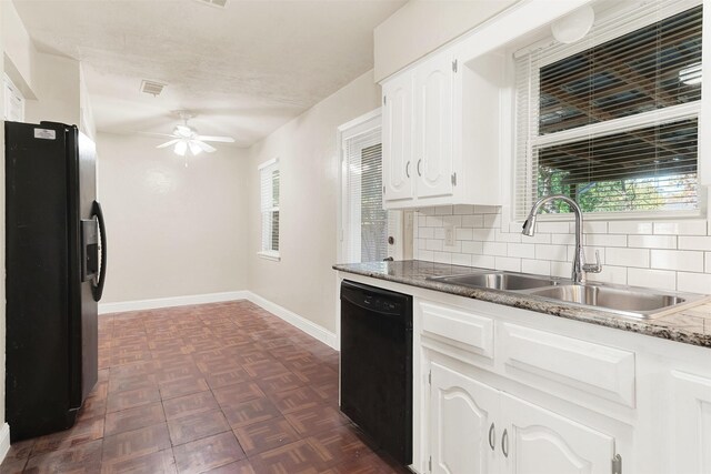 kitchen featuring tasteful backsplash, a wealth of natural light, white cabinets, and black appliances